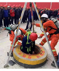 Heavy Duty Confined Space Tripod With Rescue Winch And Fall Protection Gear For Manholes Wells And Sewers assisting entry into a manhole.