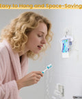 Person using Four Pack Toothpaste Squeezers Hanging Tube Squeezer Tool Multicolor Tubular Paste Dispenser Save Every Last Drop For Toothpaste