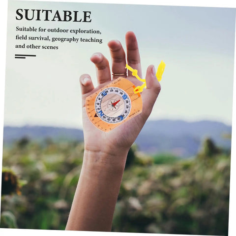 Hand holding Trail Ready Orienteering Compass Tool With High Precision For Hiking And Camping Luminous Dial For Night Use outdoors.