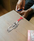 Adjustable Metal Toggle Latch Clamp With Strong Grip for Sliding Doors shown on a workbench with tool in hand