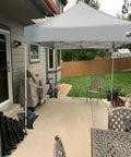 130 Lbs 4 Pack Universal Canopy Weights with reinforced double pockets securing a gazebo on a patio, heavy-duty sandbags visible