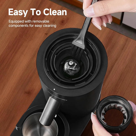Aaobosi Cordless Burr Coffee Grinder Rechargeable With 60 Settings And Anti Static Design Digital Timer Touchscreen, cleaning the burr with brush.