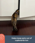 Cat attempting to enter cabinet, showing Sliding Cabinet Locks 3 Pack White For Kid Safe Latches Easy Install Childproof Locks in use.