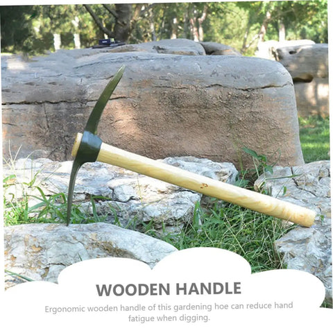 Wooden handle pickaxe on rocks in garden with ergonomic design for efficient weeding and soil digging in vegetable and flower gardens.