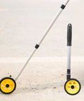 KIMISS Accurate Extendable Measuring Wheel for Construction, Lightweight on a surface, showcasing yellow wheels and aluminum rods.