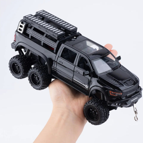 Hand holding 1/24 Diecast Pickup Truck Toy With Light And Sound, Pull Back Action Metal Truck For Kids And Collectors, Black Mammoth Model.