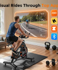 Man on magnetic indoor exercise bike with exclusive app and real-time data display, ultra quiet home studio cycling setup.