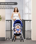 Woman with stroller beside 36 Inch Tall Stair Baby Gate With Door, Extra Wide Adjustable From 29.3 Inches To 51.5 Inches, Pressure Mounted