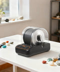 Pro Grade Rock Tumbler Kit 3 lb capacity with TPU drum on a table, surrounded by polished stones, shown in a bright room.