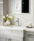 Wellton No-Fuss One-Handle Bathroom Faucet In Spot Resist Brushed Nickel installed on a modern marble vanity with a floral arrangement.