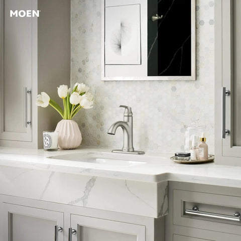 Wellton No-Fuss One-Handle Bathroom Faucet In Spot Resist Brushed Nickel installed on a modern marble vanity with a floral arrangement.