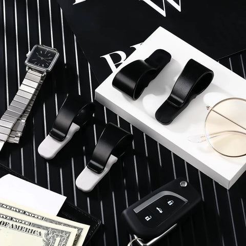 Car Visor Clip Set With Silicone Non Slip Pad Keeps Sunglasses And Glasses Handy Plus Pen Holder Ticket Clip And Sun Visor Hanger For Vehicle Four Pack In Black And White on a flat surface with accessories.