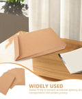 Kraft Self Seal Mailing Envelopes 238x335x40mm with double sided adhesive tape on wooden table for shipping documents and clothing