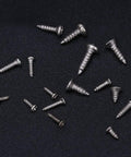 Top Notch Mini Self Tapping Screws With Rounded And Countersunk Cross Heads Crafted From Durable Stainless Steel placed on a black surface.