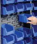 Heavy Duty Deep Door Bin Cabinet With 132 Blue Plastic Parts Organizers For Warehouse And Mobile Garage Setup featuring blue bins being adjusted.