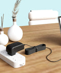 Dope 18V AC DC Power Adapter Compatible With Dremel 2050 Rotary Tool on a power strip, black adapter with cable on a wooden desk.