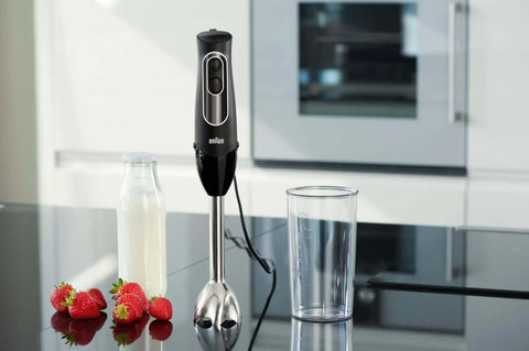 Game Changer 350 Watt Hand Blender With Beaker And Whisk Attachment, stainless steel blades, black handle, milk bottle, strawberries.