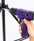 Hand holding 8V purple cordless drill in use from 20 Piece Tool Set With 8V Purple Cordless Drill And Home Tool Kit For Quick Fixes Includes 18 Accessories And Type C Cable