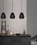7 Inch Woven Rattan Pendant Light Black Boho Basket Fixture For Farmhouse Kitchen Island, Bedroom, And Living Room Modern Hanging Lamp Set Of 3 With Hand Woven Natural Twine For A Cozy Vibe Glow in a kitchen setting.