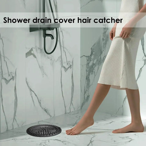 Heavy Duty Hair Catcher Shower Drain Protector And Tub Filter For Bathtub And Sink Made From Top Quality Stainless Steel With Gentle Silicone Border, black round strainer in shower with woman's foot.