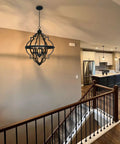 Six Light Rustic Farmhouse Chandelier With Walnut Wood Grain Metal Finish And Textured Black Accents in modern staircase