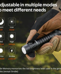 Gloved hand holding Super Bright High Lumen EDC Flashlight With 90 CRI LED 1200 Lumens Rechargeable Magnetic Tail showing mode options.