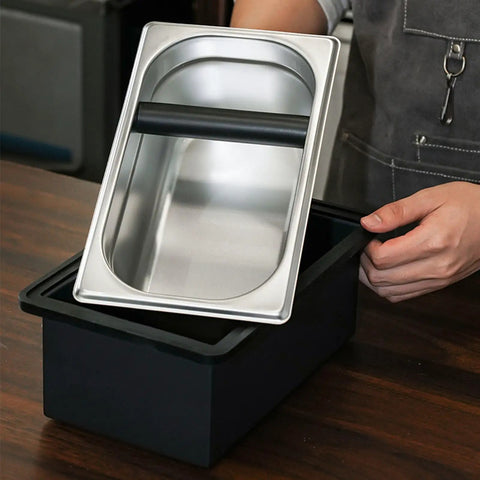 Built Like A Tank Stainless Steel Knock Box With Removable Interior Grounds Bin, shiny silver bin on black base, perfect for espresso setups.