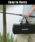 Person holding 6.9ft Telescopic Fishing Pole And Reel Kit with carrier bag in front of pond