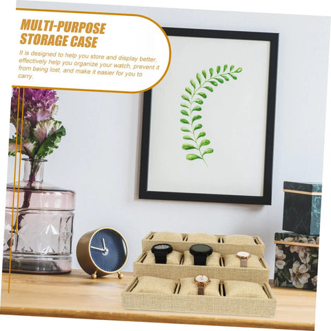 Slick Linen Watch Organizer Tray With Nine Generous Grids For Snagging And Showcasing Your Favorite Timepieces Plus Luxury Jewelry Collection Top Shelf Desk Storage Solution displaying three watches on a wooden surface.