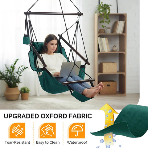 Woman sitting on upgraded unique hammock hanging sky chair with easy setup safer design air deluxe swing seat in green color.
