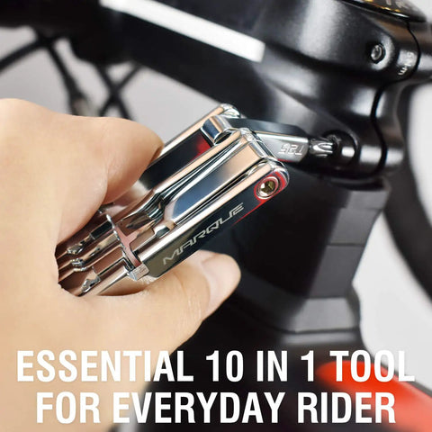Hand using 10 In 1 Bike Multitool For Road And Mountain Bikes Ultra Compact Pocket Repair Kit With 10 Tools on bike part.