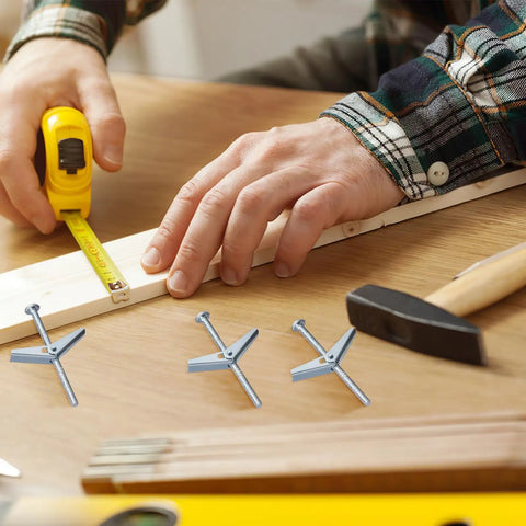 Person measuring wood with tape alongside 20 Piece Wing Nut And Bolt Kit With Toggle Bolts For Drywall And Heavy Duty Fastening