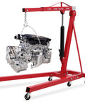 Sturdy Fold Down Engine Hoist With Long Lever And Six Heavy Duty Casters Two Ton Hydraulic Shop Crane Cherry Picker Lifting Rig holding an engine.