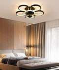 Dope 20 Inch Modern Ceiling Fan With Integrated Led Chandelier Light, Sleek Black And Gold Flush Mount Design, Three Speed Remote Control And Timer Function For Chill Home Vibes in a modern bedroom interior.