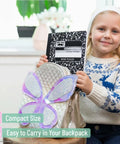 Child holding Bulk 24 Pack Composition Notebooks With 50 Sheets Each, Wide Ruled, 9.75 By 7.5 Inches, Hard Cover Black Marble, in backpack