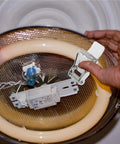 Person installing a 24 Pcs Metal Downlight Spring Clips for Recessed Lighting 3-Hole Brackets on a ceiling fixture.
