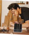 Person using Pin Punch Set 28Pc Cylindrical Punches Drilling Tools Maintenance Kit for home repairs on wooden surface.