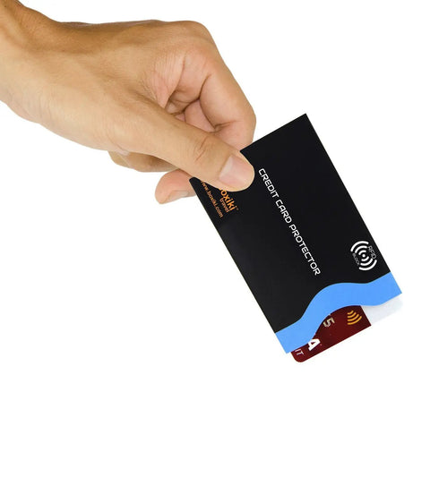 Hand holding black and blue RFID Blocking Travel Sleeves Set With Color Coding Navy Blue Unisex Wallet, protecting credit card