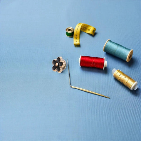 Total Fashion Hack With These Pocket Ready Black Flower Button Covers And Alloy Brooch Pins For Dresses No Sew Snap Fasteners on blue fabric with sewing supplies.