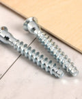 Close-up of 100 Pack M7x50mm Hex Socket Countersunk Self Tapping Screws For Heavy Duty Furniture Cabinets And Wood Projects Zinc Plated