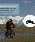 Biker with mountains in background and hydraulic mountain bike brake bleed kit with mineral oil funnel set inset view