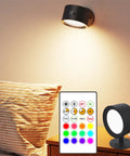 Rechargeable Battery Operated Wall Sconce Twin Pack With 3 White And 13 RGB LED Lights illuminated beside a bed with remote