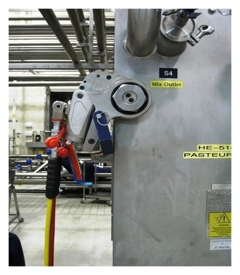 Heavy Duty Hydraulic Torque Wrench Featuring Hollow Body And Square Drive Built Like A Tank For Knocking Down Stubborn Bolts Ridiculously Precise Garage Ready Gear attached to machinery with hoses.