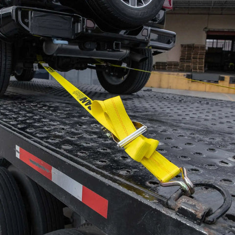 Ratchet Straps With Wire J Hooks, 2In x 15Ft, Four Pack, Classic Yellow Webbing securing vehicle to flatbed trailer