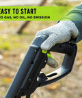 Close-up of 16 Inch Corded Electric Tiller With 13.5 Amp Motor handle, showcasing easy start feature, glove-covered hand.