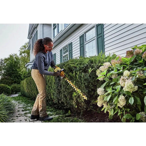User trimming hedge with Badass Cordless Hedge Trimmer Equipped With 60 Volt Lithium Battery For Knockout Yard Cleanup.