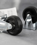Close-up of 4 Pack 3 Inch Rubber Caster Wheels With Plain Plate Top For Shelves And Trolleys Heavy Duty Noiseless Rolling Each Wheel Supports 99 Lb Ideal Replacement For Warehouse Carts on grey surface.