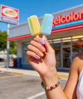 Hand holding popsicles, nails painted with Six Candy Colors Gel Nail Polish Set HEMA Free TPO Free Soak Off Gel Polish Kit 15ml UV LED Safe