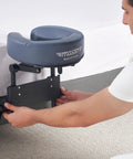 Man setting up Home Mattress Top Massage Kit In Royal Blue With Adjustable Height From 3 To 17 Inches, with headrest cushion.