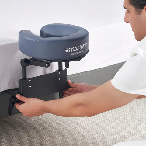 Man setting up Home Mattress Top Massage Kit In Royal Blue With Adjustable Height From 3 To 17 Inches, with headrest cushion.